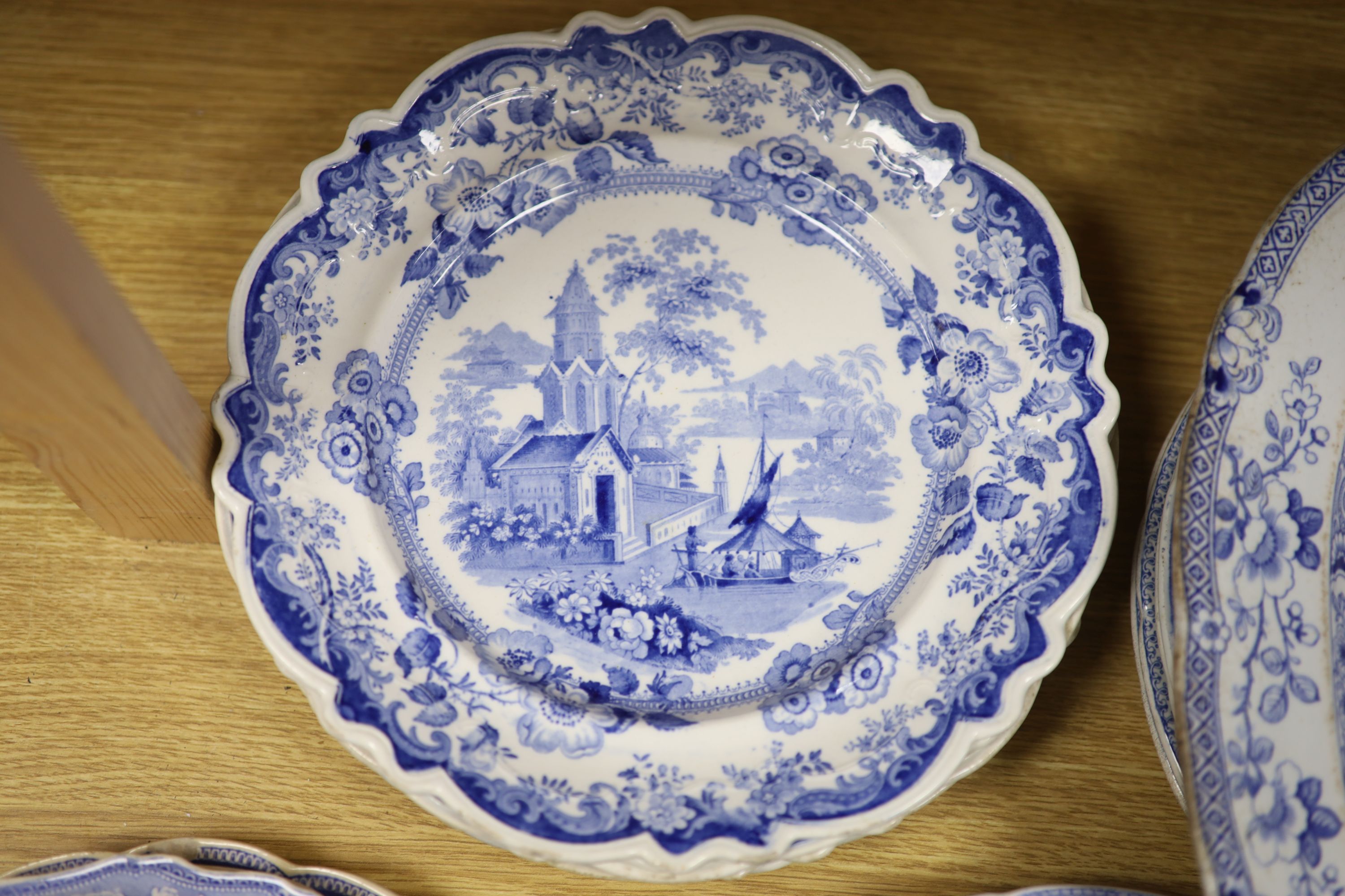 A collection of 19th and 20th century blue and white pottery plates and dishes